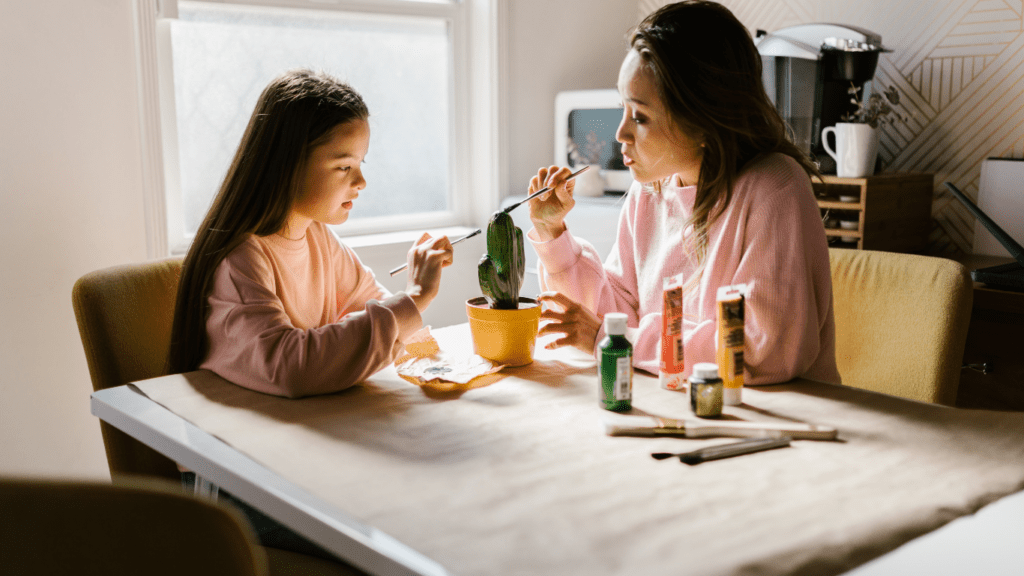 a parent and child sitting at a table