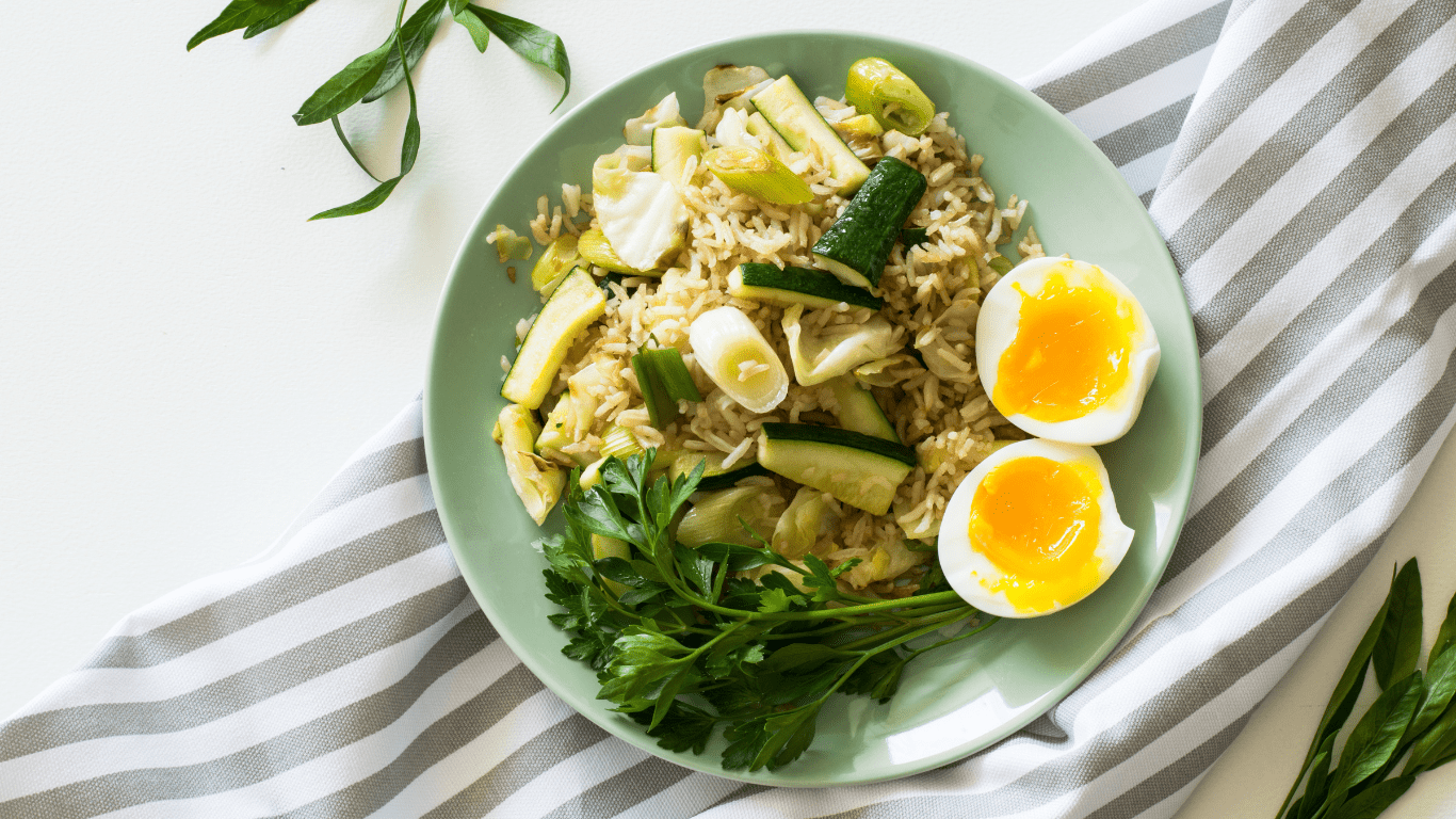 a plate with rice, vegetables and an egg