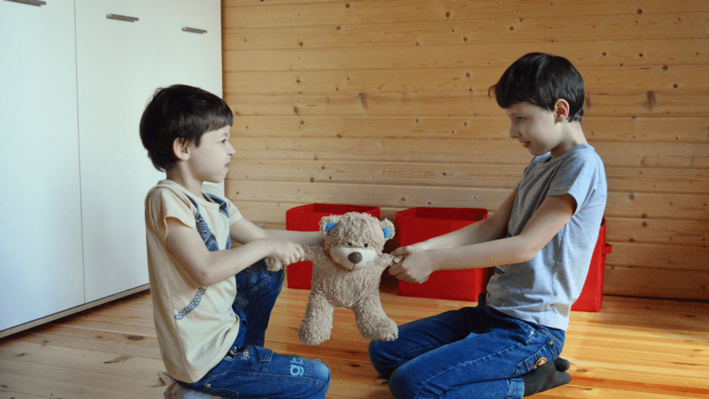 two boys are fighting and shouting