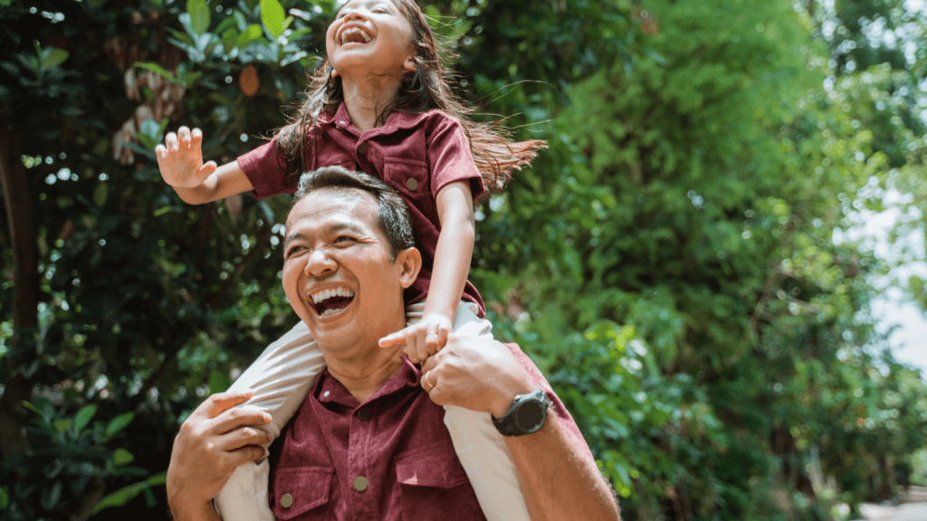 A man and his child are having fun on the road