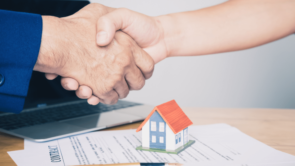 buyer and seller shake hands in real estate transaction