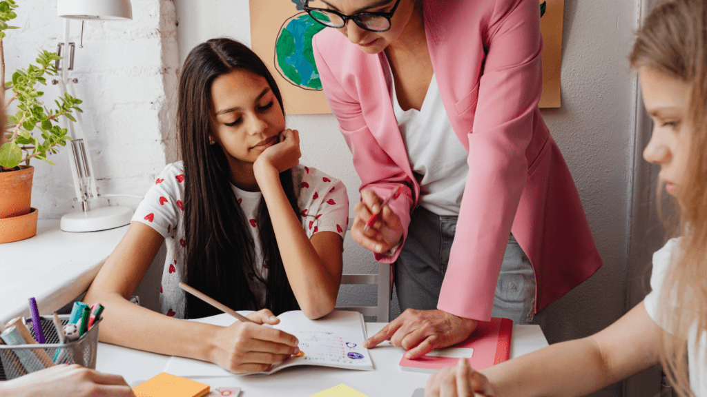 a teacher helping the students with their homework