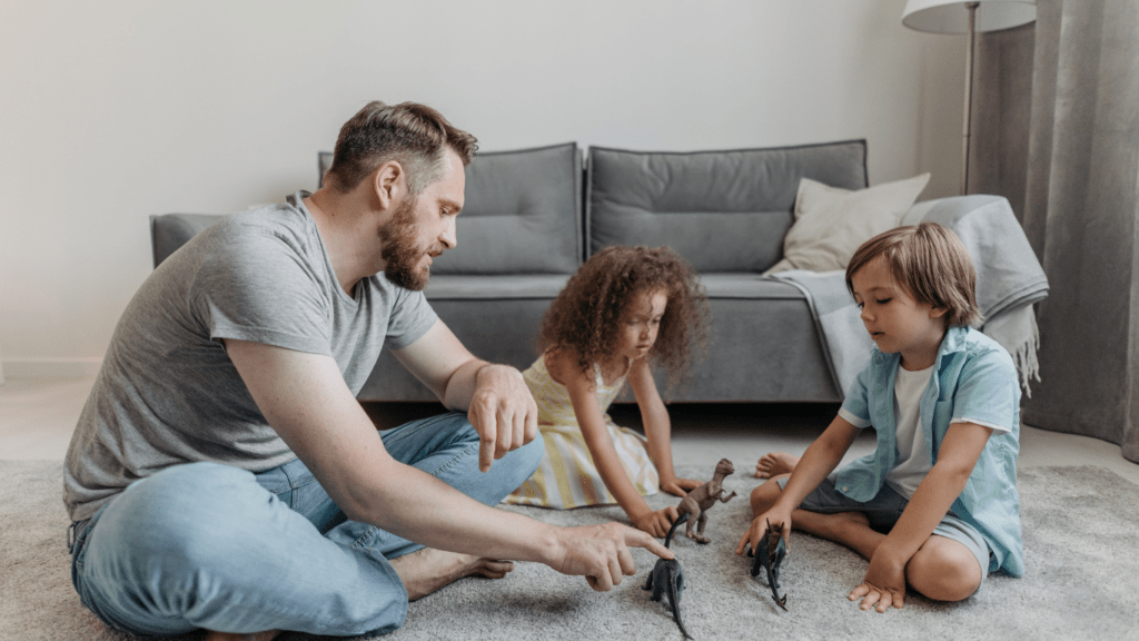 two children playing with toys in the living room