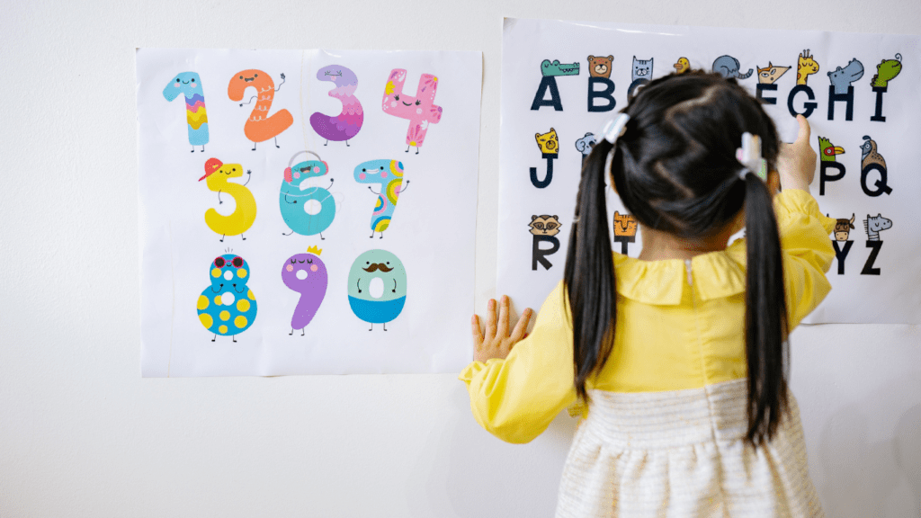 a child standing in front of a poster with numbers on it