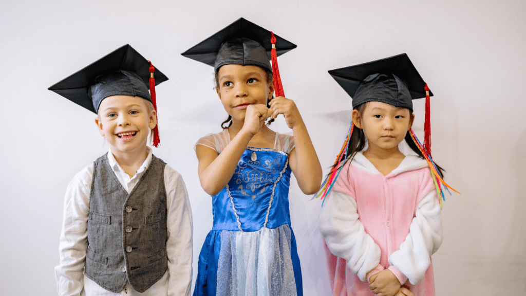 children wearing graduation caps and gowns