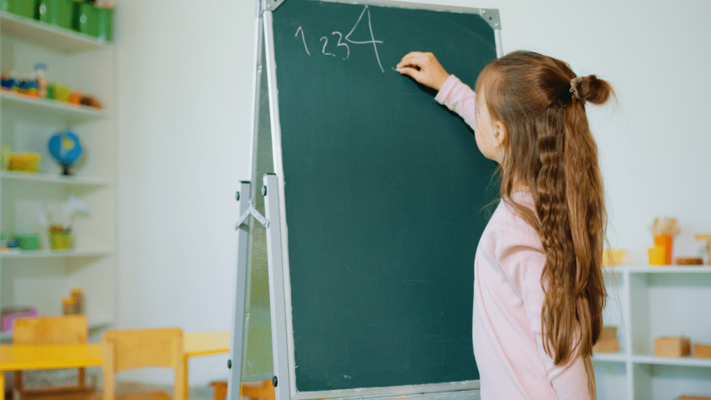 a child standing in front of a poster with numbers on it