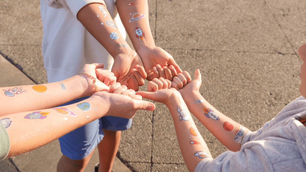 a group children putting their hands together