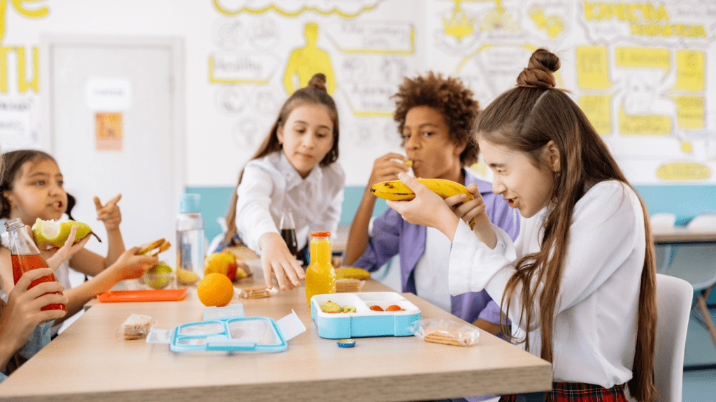 a boy eating his lunch in a school cafeteria