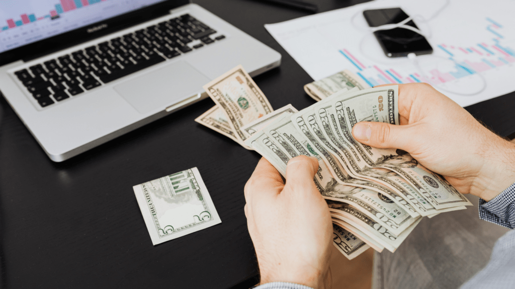 a person sitting at a table with money