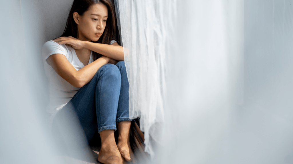 a person sitting on the floor in front of a couch