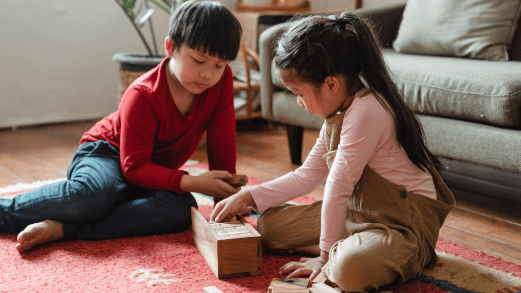 children playing with wooden blocks on the floor