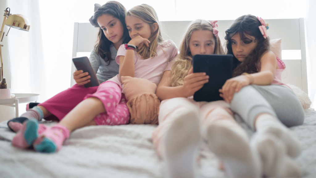 children sitting on bed