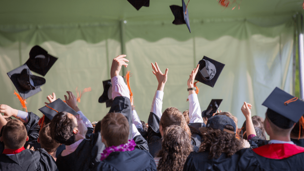 children wearing graduation caps and gowns