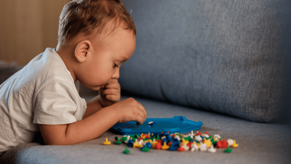 a toddler playing with toys on a couch