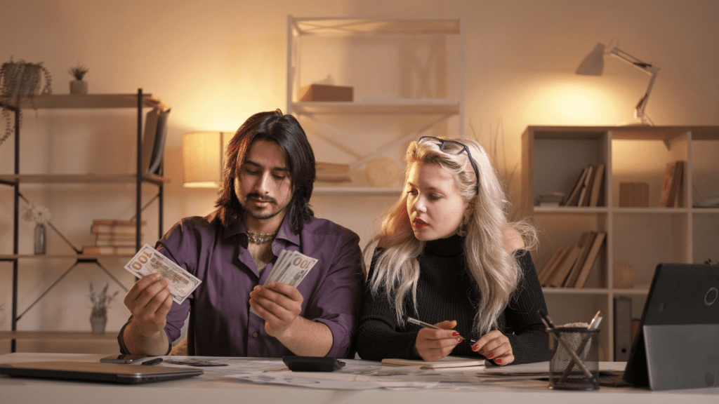 a person sitting at a table with money