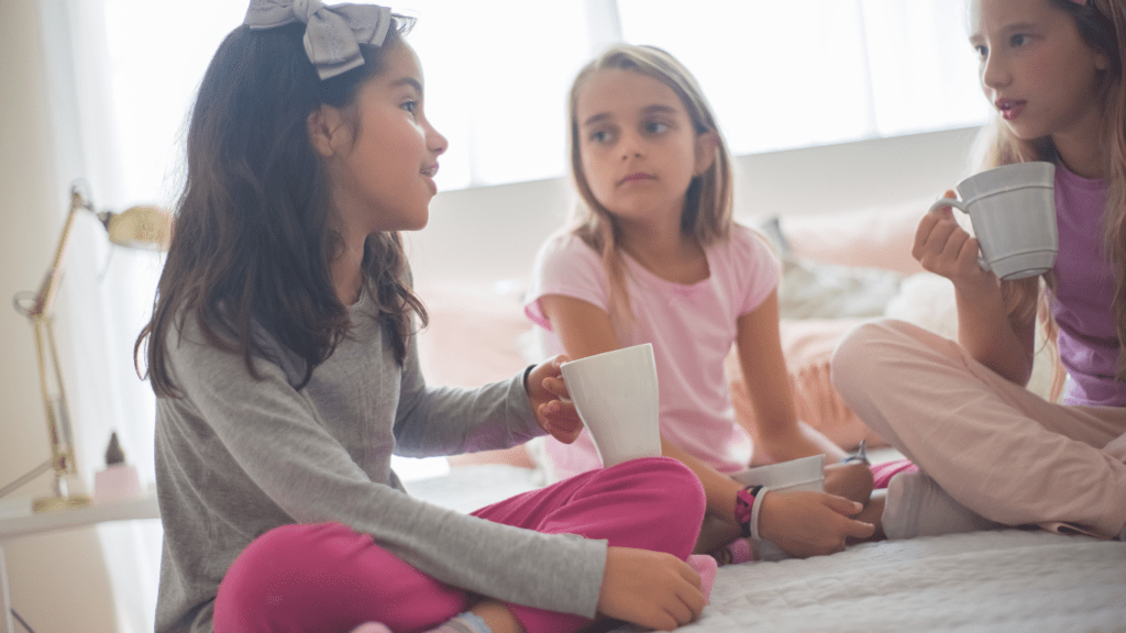 children sitting on bed