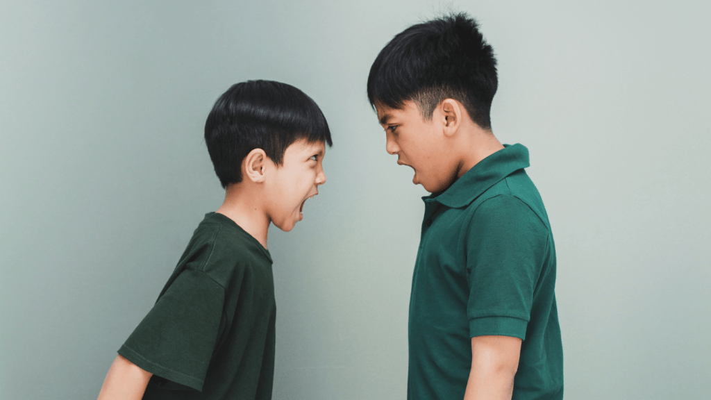 two boys are fighting and shouting