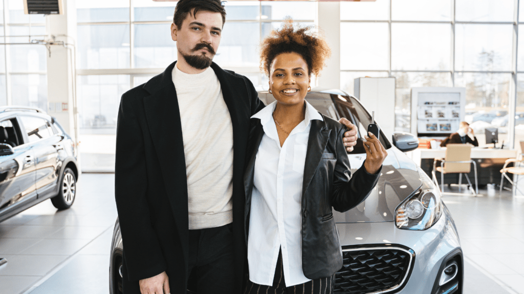 two people in a car dealership talking to each other